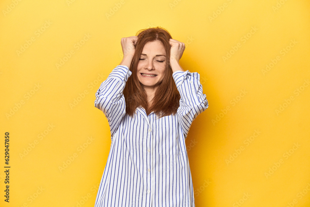 Business-dressed redhead, formal studio shot crying, unhappy with something, agony and confusion concept. Business-dressed redhead, formal studio shot crying, unhappy with something, agony and confusion concept.
