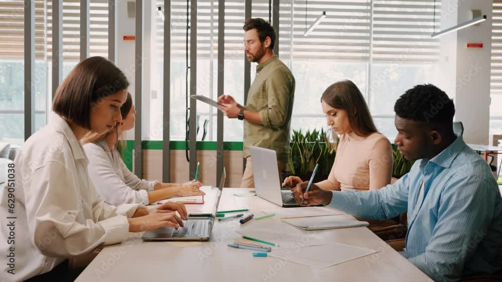 Manager gives tasks to employees at company business meeting Manager gives tasks to employees at company business meeting