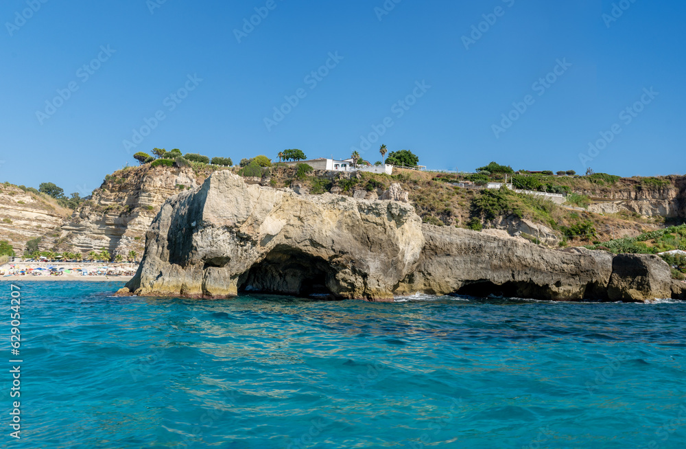 View of coastline in southern Italy. Scenic view from the boat on sunny summer day. Calabria rocky shore View of coastline in southern Italy. Scenic view from the boat on sunny summer day. Calabria rocky shore