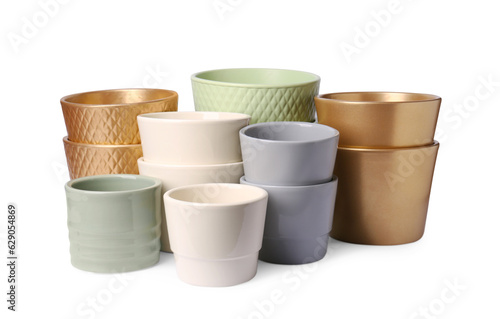 Many different empty ceramic flower pots on white background