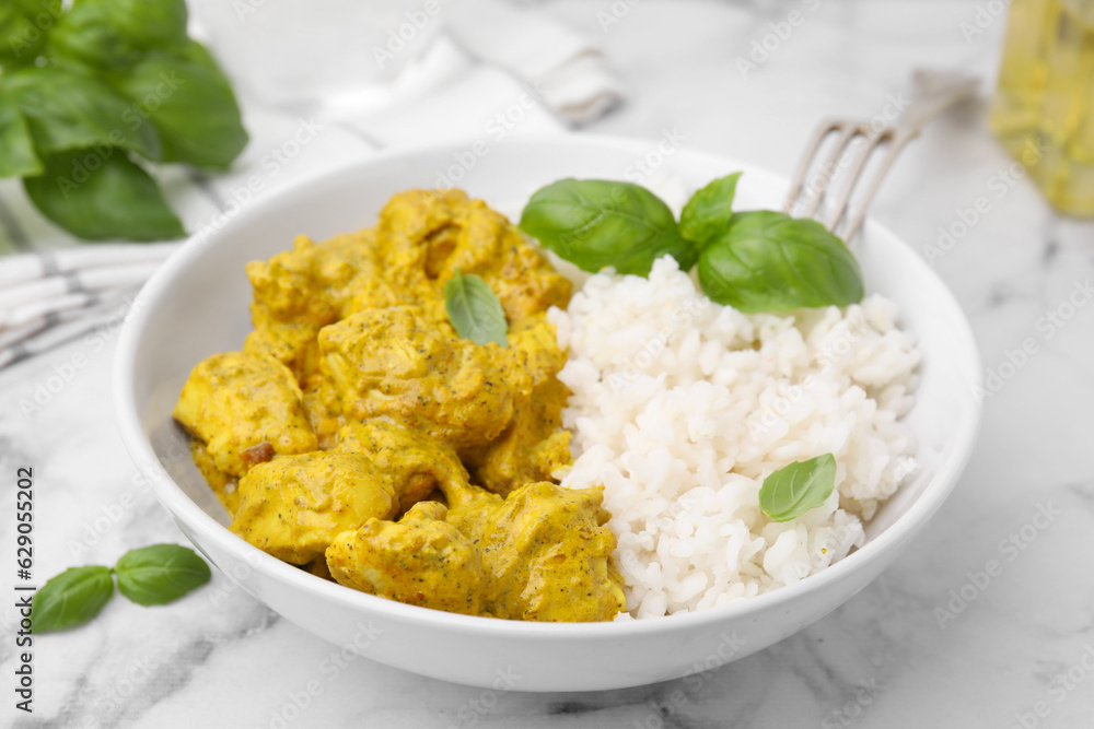 Delicious rice and chicken with curry sauce on white marble table, closeup Delicious rice and chicken with curry sauce on white marble table, closeup