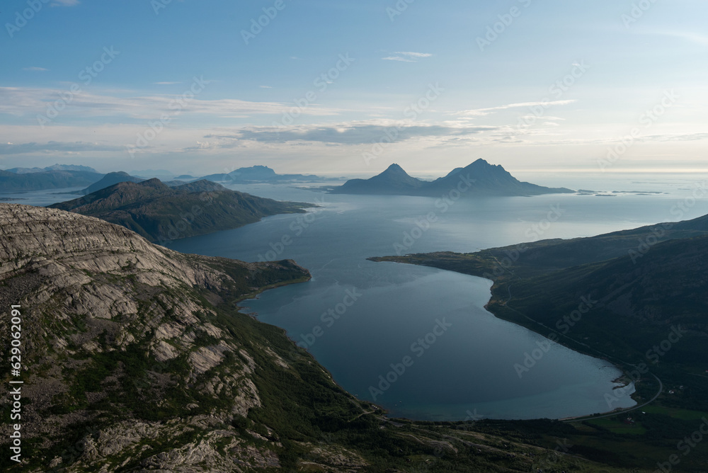 Afternoon view from Smaltinden, Luröy, Helgeland, NordNorge. View over Norwegian island of Tomma, across sjona. Mountains on islands in Norway. Tower of rocks in the foreground. Beautiful Norway hike.