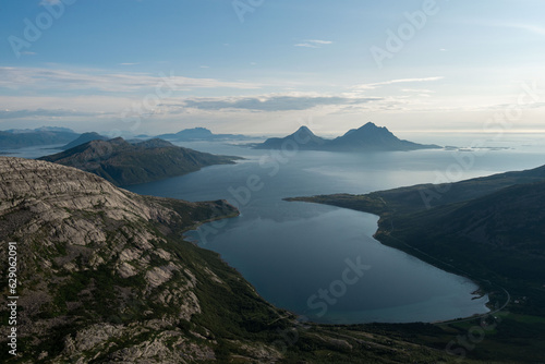 Fototapeta Naklejka Na Ścianę i Meble -  Afternoon view from Smaltinden, Luröy, Helgeland, NordNorge. View over Norwegian island of Tomma, across sjona. Mountains on islands in Norway. Tower of rocks in the foreground. Beautiful Norway hike.