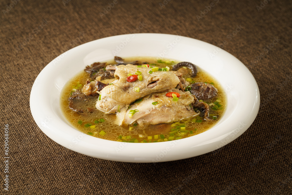Special Chinese food stewed chicken with mushrooms on retro dark background Special Chinese food stewed chicken with mushrooms on retro dark background
