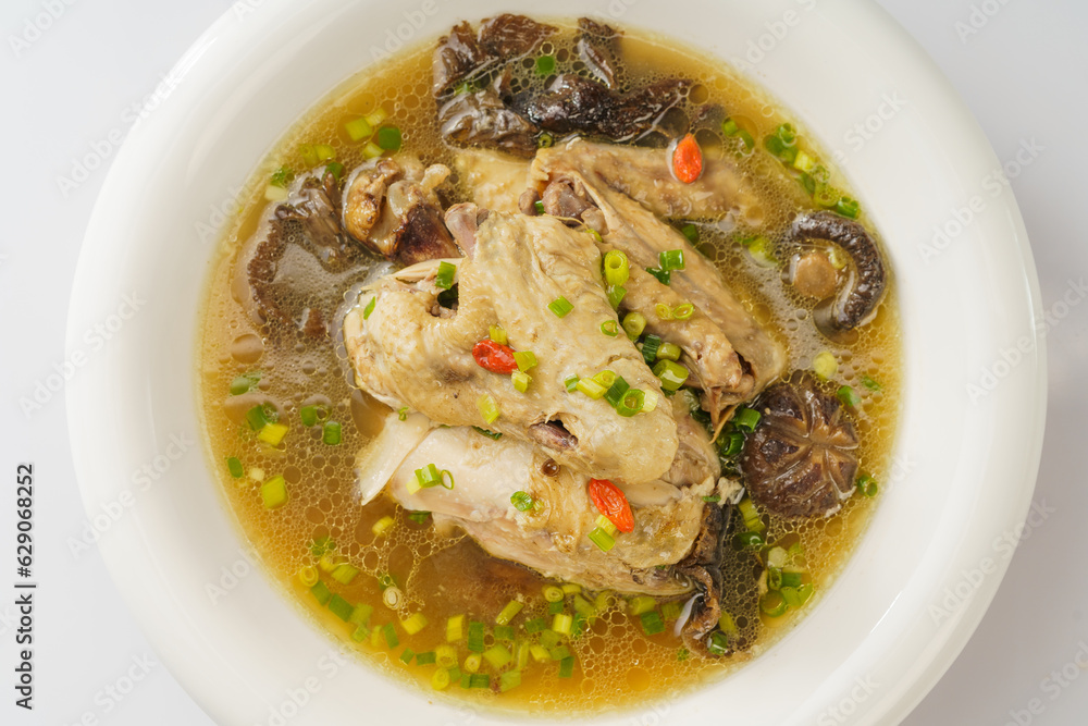 Special Chinese food stewed chicken with mushrooms on retro dark background Special Chinese food stewed chicken with mushrooms on retro dark background