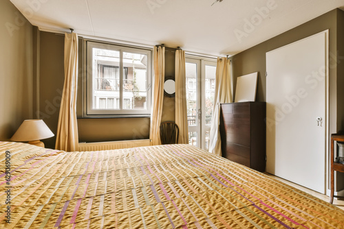 a hotel room with a bed, dresser and television set in the corner next to an open sliding glass door