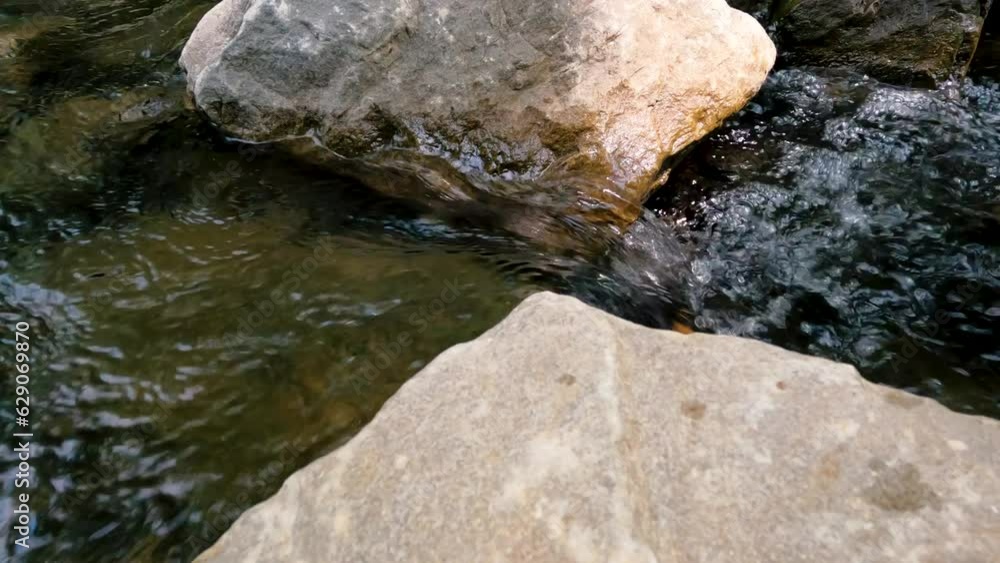 Closeup views of a flowing river. The water sprays and splashes over the large rocks in the river. Located within Shawnee National Forest in Southern Illinois, USA. Closeup views of a flowing river. The water sprays and splashes over the large rocks in the river. Located within Shawnee National Forest in Southern Illinois, USA.