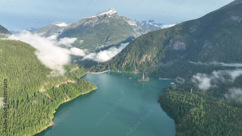 Forest-covered slopes surround scenic Diablo Lake in North Cascades National Park. This mountainous region of northern Washington is absolutely beautiful and easily accessed during summer months. Forest-covered slopes surround scenic Diablo Lake in North Cascades National Park. This mountainous region of northern Washington is absolutely beautiful and easily accessed during summer months.
