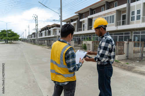 Engineer team discussing and working at outdoor construction site Inspect locations, paths, building models, structural house models in village projects and buildings to meet standards and strength.