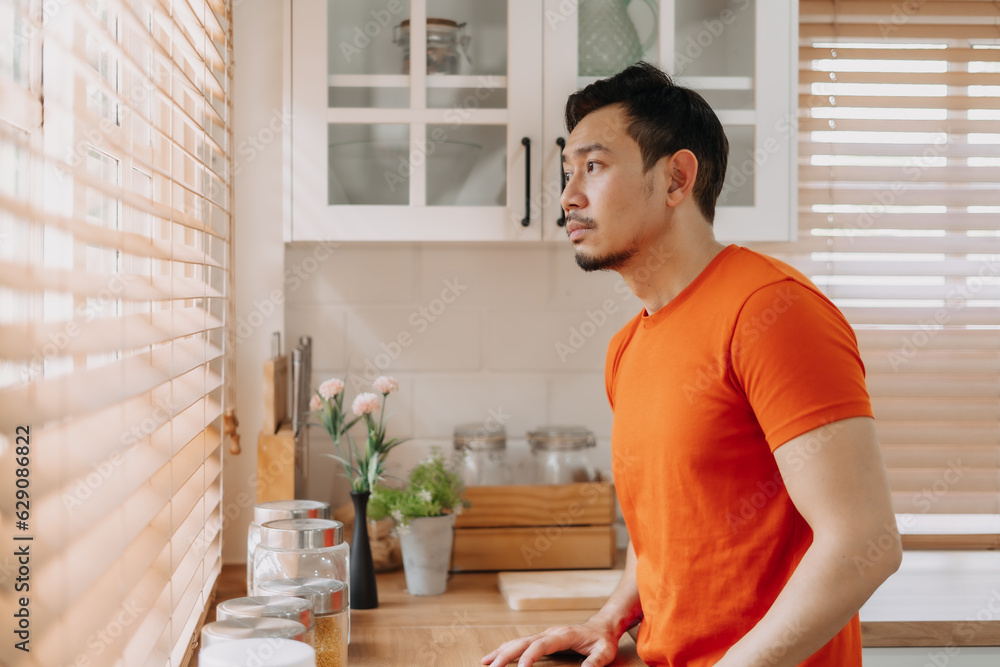 Asian man calm in the kitchen in the morning prepare his easy breakfast. Asian man calm in the kitchen in the morning prepare his easy breakfast.