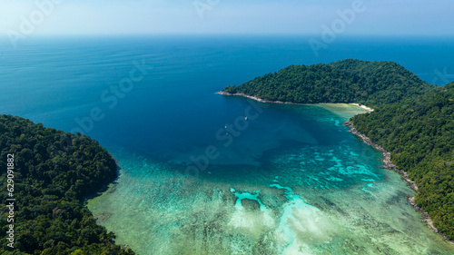 Aerial view with the island with the tropical Summer with wave water as white sand beach background. © SASITHORN