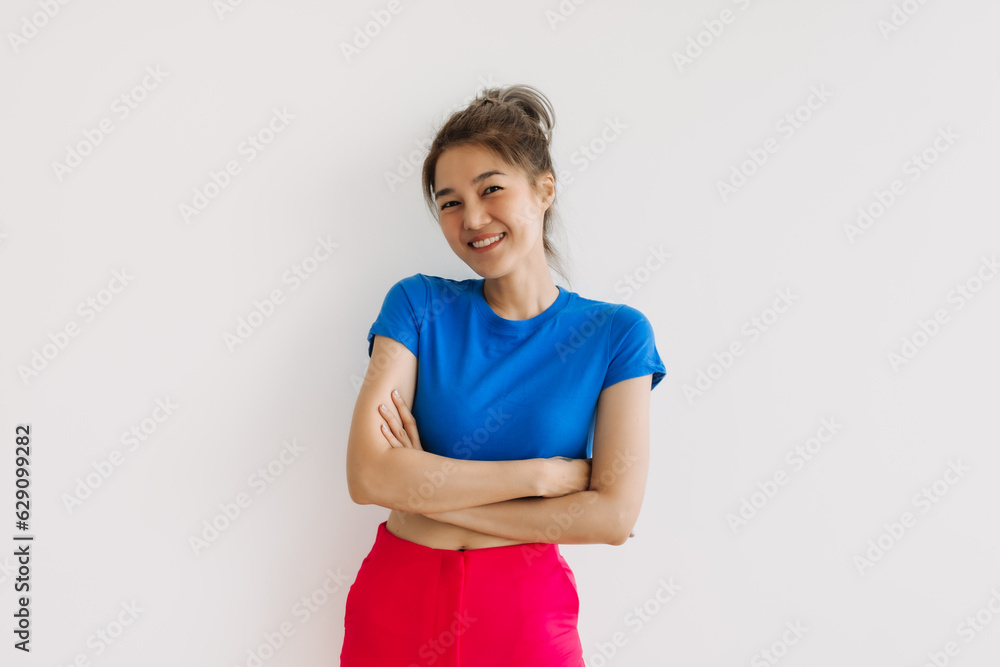 Smile and laughing asian woman with crossed arms isolated on white. Smile and laughing asian woman with crossed arms isolated on white.