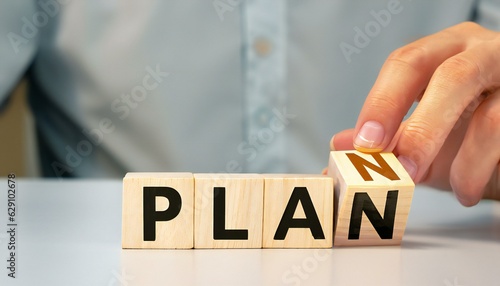 PLAN word from wooden blocks on a Table 