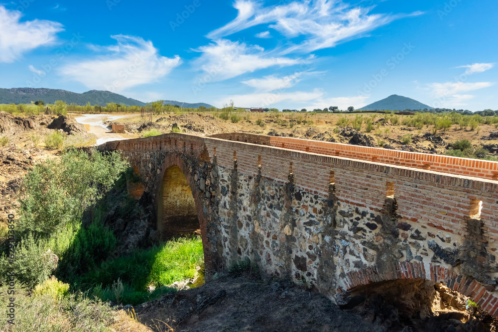 Roman stone bridge that crosses a small stream that leads to the summit of the nearby mountains, Agudo, Ciudad Real.