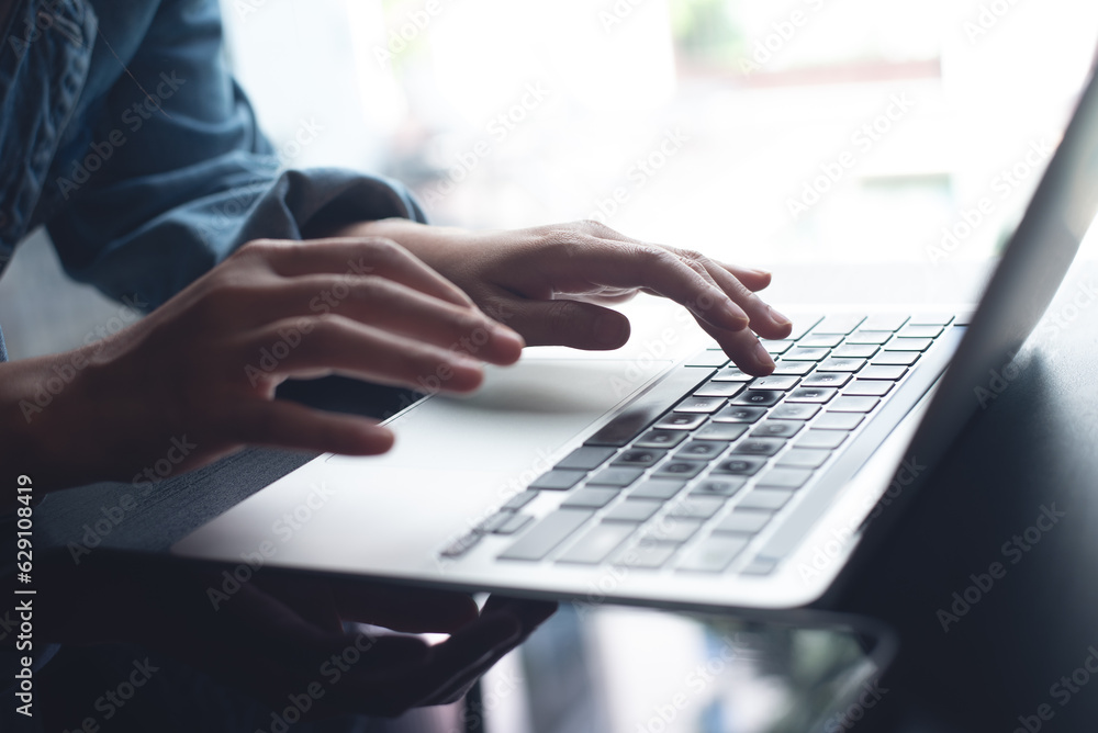 Close up of business woman hands working, typing on laptop computer keyboard, surfing the internet on office desk, online working, telecommuting, freelancer at work concept Close up of business woman hands working, typing on laptop computer keyboard, surfing the internet on office desk, online working, telecommuting, freelancer at work concept