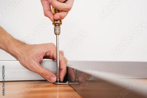 Tableau sur toile Assembling wooden table with screwdriver