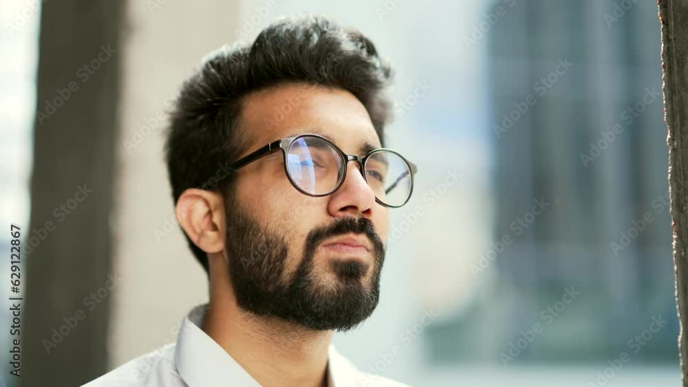 Side view Close up portrait of a confident businessman in a white shirt and glasses looking to the side. Handsome serious bearded male standing on the street outside Thoughtful developer IT specialist Side view Close up portrait of a confident businessman in a white shirt and glasses looking to the side. Handsome serious bearded male standing on the street outside Thoughtful developer IT specialist