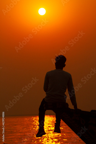 Boy's hand does a heart shape on a sunset beach natural tropical background. Enjoy the Beautiful Sunset moment,