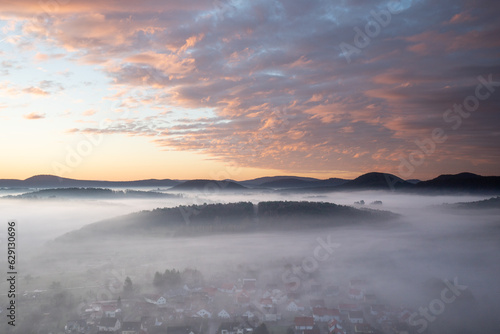 Mystical Sunrise at Wachtfelsen, Palatinate Forest. Captivating landscape shot amidst fog and clouds near Wernersberg, Germany photo