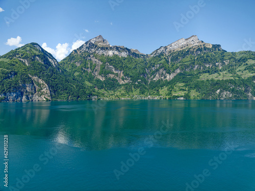 Scenic view of Lake Uri with beautiful mountain panorama and village Bauen on a sunny spring day. Photo taken May 22nd, 2023, Sisikon, Switzerland.