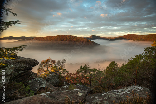 Mystical Sunrise at Wachtfelsen, Palatinate Forest. Captivating landscape shot amidst fog and clouds near Wernersberg, Germany photo