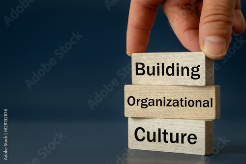 A wooden block with the words Building, Organizational, Culture, Modern approach to working with people in a team, Creative concept, copy space