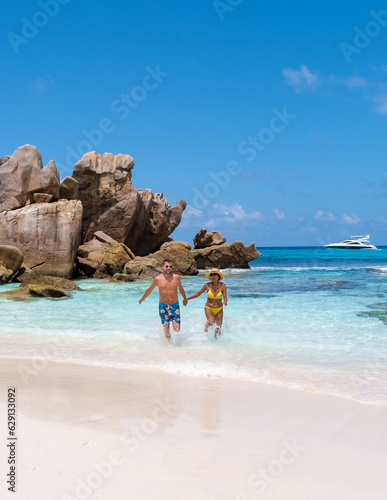Anse Cocos La Digue Seychelles, a young couple of men and women on a tropical beach during a luxury vacation in Seychelles.  © Fokke Baarssen