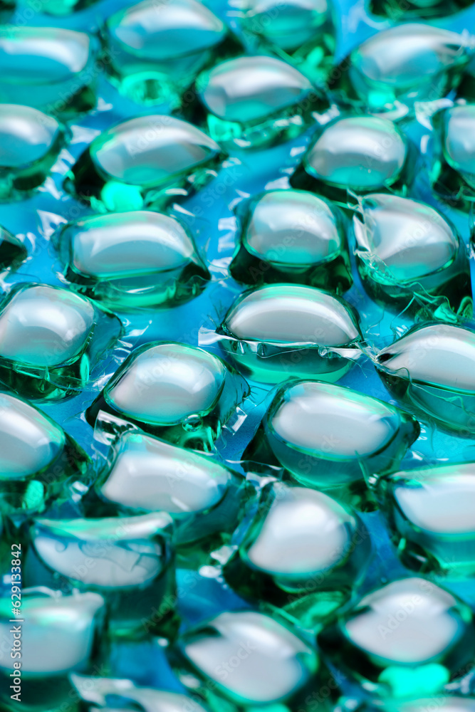 Background lot of capsules for washing green on blue background. Background lot of capsules for washing green on blue background.