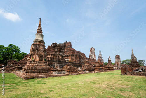 Ruins of ancient city temples Ayutthaya, Thailand. Old kingdom of Siam. Summer day with blue sky. Famous tourist destination, spiritual place near Bangkok.