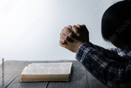 Christian life crisis prayer to god. Woman Pray for god blessing to wishing have a better life. woman hands praying to god with the bible. begging for forgiveness and believe in goodness.