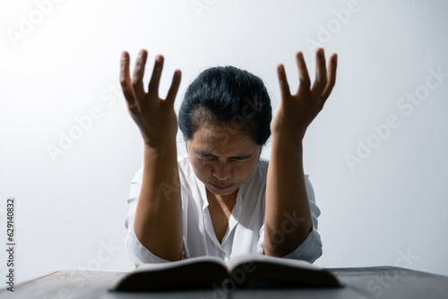 Christian life crisis prayer to god. Woman Pray for god blessing to wishing have a better life. woman hands praying to god with the bible. begging for forgiveness and believe in goodness.