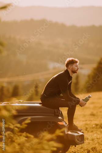 Young man relaxing on a ter...