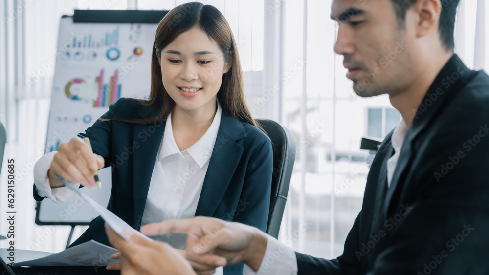 Group of financial advisors sitting at the table and listening to their manager during a meeting at office in the morning. Group of financial advisors sitting at the table and listening to their manager during a meeting at office in the morning.