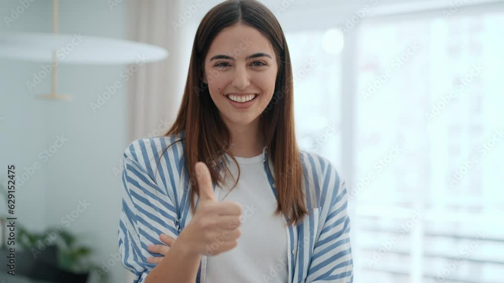 Video of beautiful smiling woman looking at camera while standing in living room at home. Video of beautiful smiling woman looking at camera while standing in living room at home.