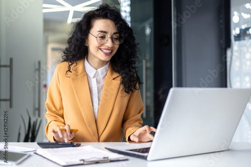 Mature successful financier accountant on paper work with papers, documents contracts and charts graphs, businesswoman boss with calculator smiling happy with achievement results, inside office.