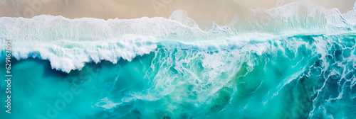 Top view Aerial perspective of a wave breaking in shallow water, creating a beautiful turquoise-colored cascade.