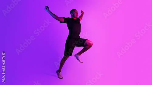 Emotional black runner shaking fists running on purple neon background