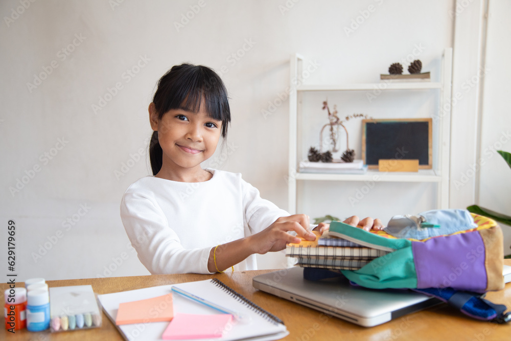 Pupil child put books and notes into backpack. School supplies.Back to school concept. Kid prepare for studies. Portrait cute little girl packing backpack . Pupil child put books and notes into backpack. School supplies.Back to school concept. Kid prepare for studies. Portrait cute little girl packing backpack .