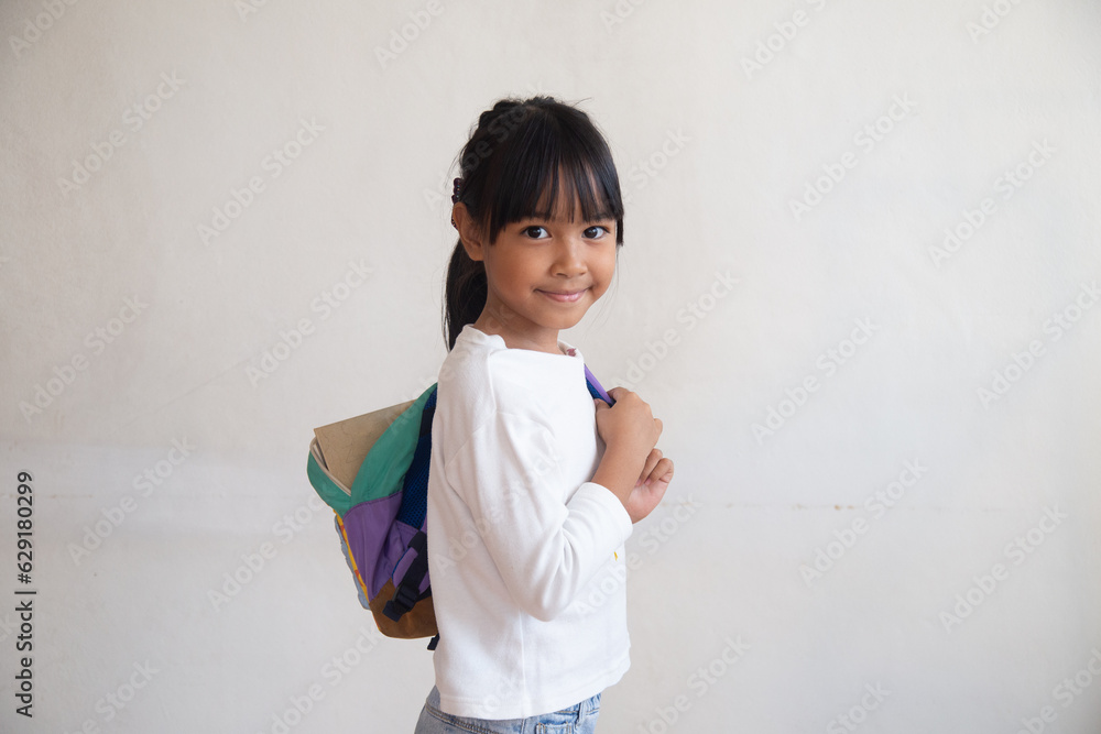 portrait a student carrying a backpack behind a white background. portrait a student carrying a backpack behind a white background.