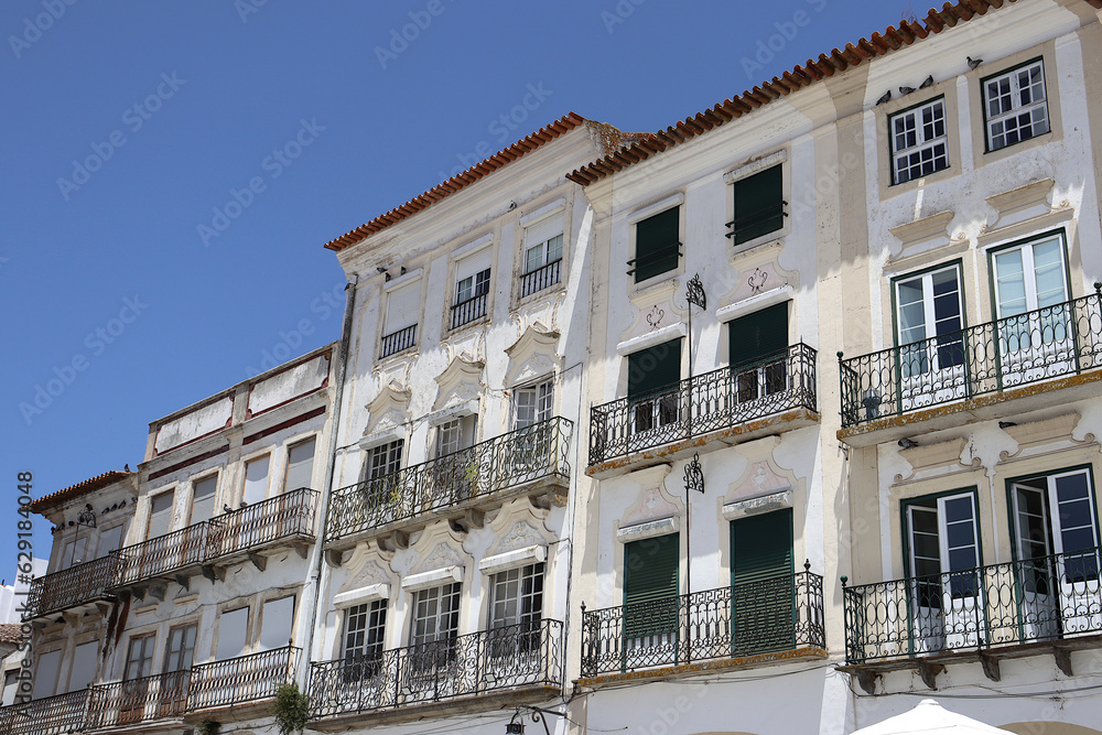 Facades of typical buildings at the main square of the city: Praça do Giraldo, Évora, Alentejo, Portugal