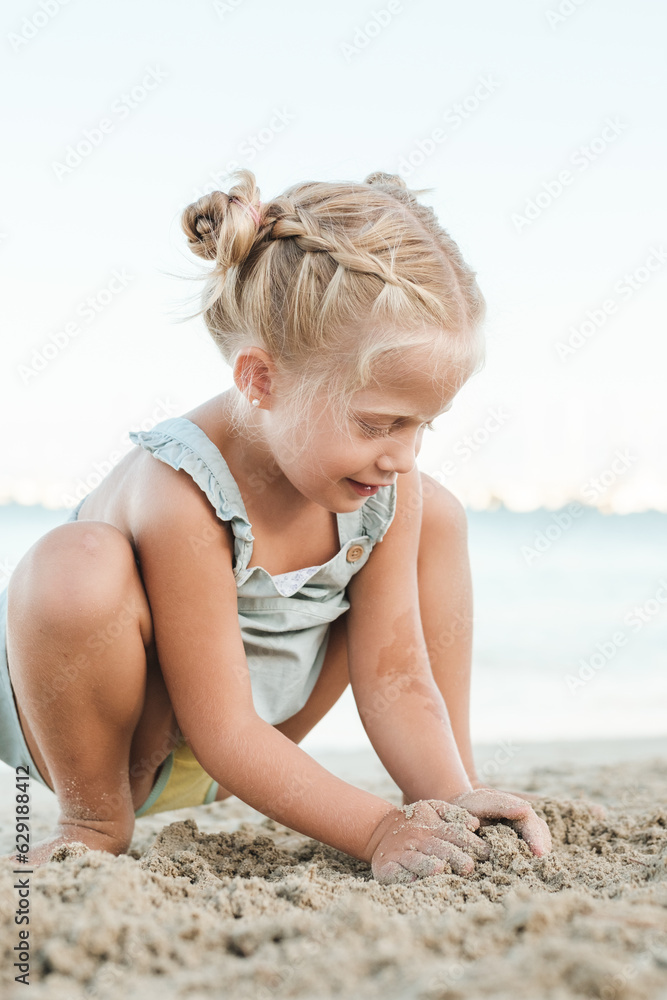 Cute girl playing with sand on beach Cute girl playing with sand on beach
