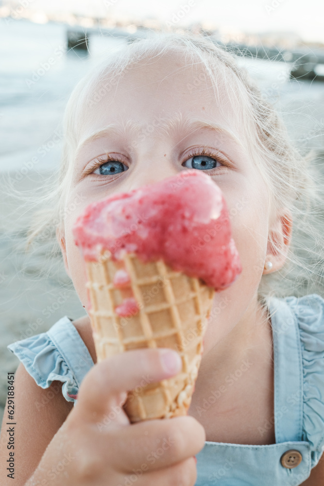 Funny kid enjoying ice cream cone in nature Funny kid enjoying ice cream cone in nature