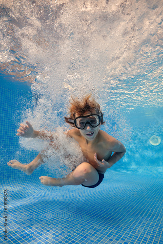 Boy jumping in bubbling water of pool