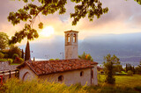 Landscape with little church at sunrise in Limone sul garda town, Garda Lake, Italy