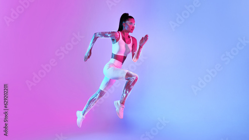 Fitness Lady Jumping Running In Mid-Air Over Neon Background