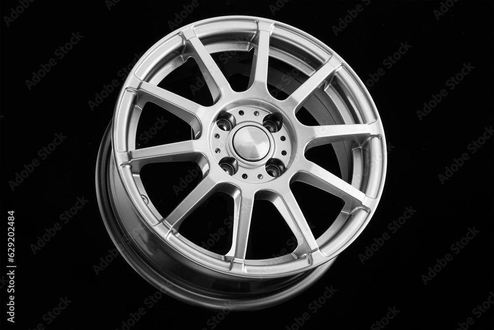 Sports silver cast disc on a black background. wheels and auto parts Sports silver cast disc on a black background. wheels and auto parts