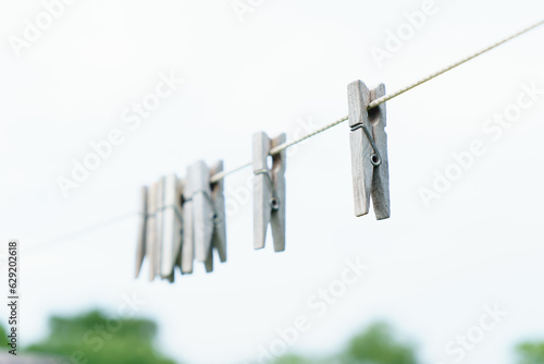 Wooden clothespins on a rope. © Сергей Косилко