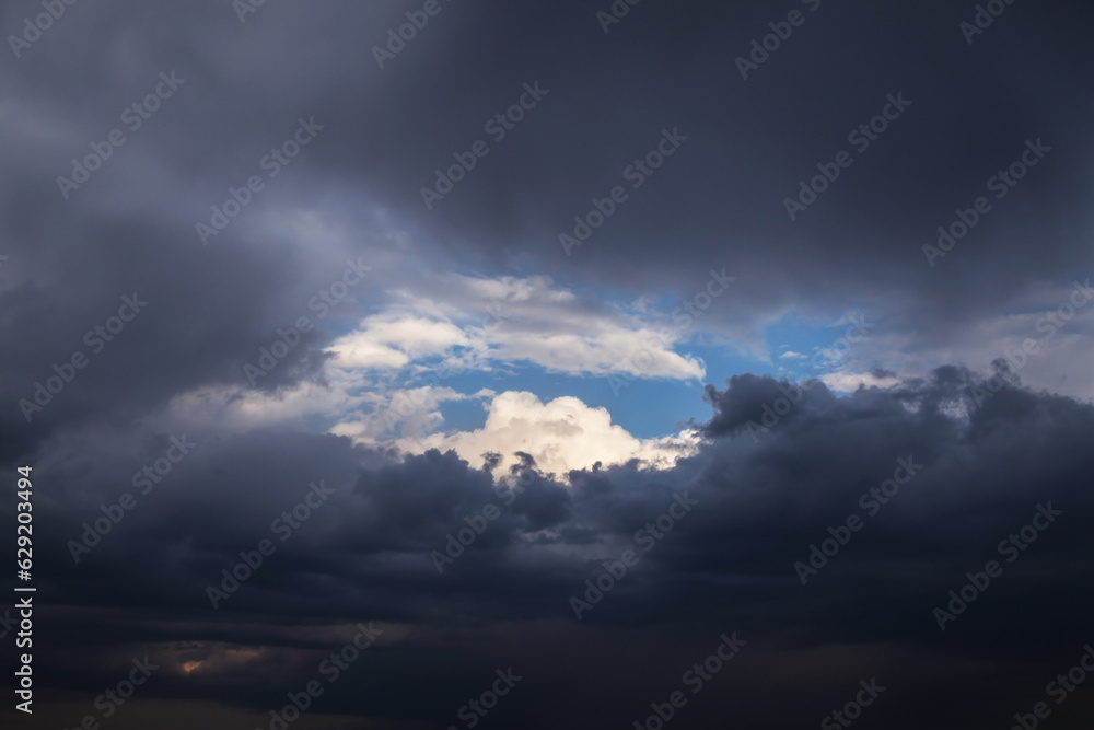 Epic Dramatic storm dark grey cumulus rain clouds against blue sky background texture, thunderstorm Epic Dramatic storm dark grey cumulus rain clouds against blue sky background texture, thunderstorm
