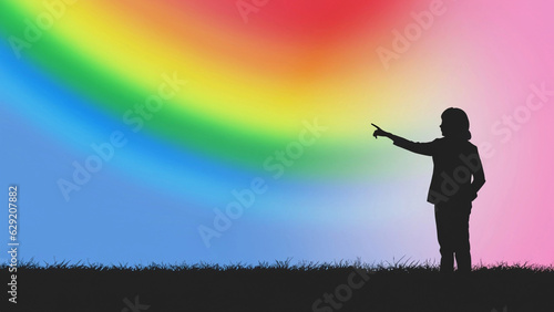 silhouette of a girl pointing toward a rainbow in the background with space to write your text 
