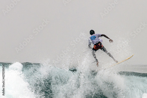 A surfing gay in the sea in Sri Lanka. © rijkkaa